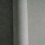 Non-woven wallpaper in grey tone with vinyl surface